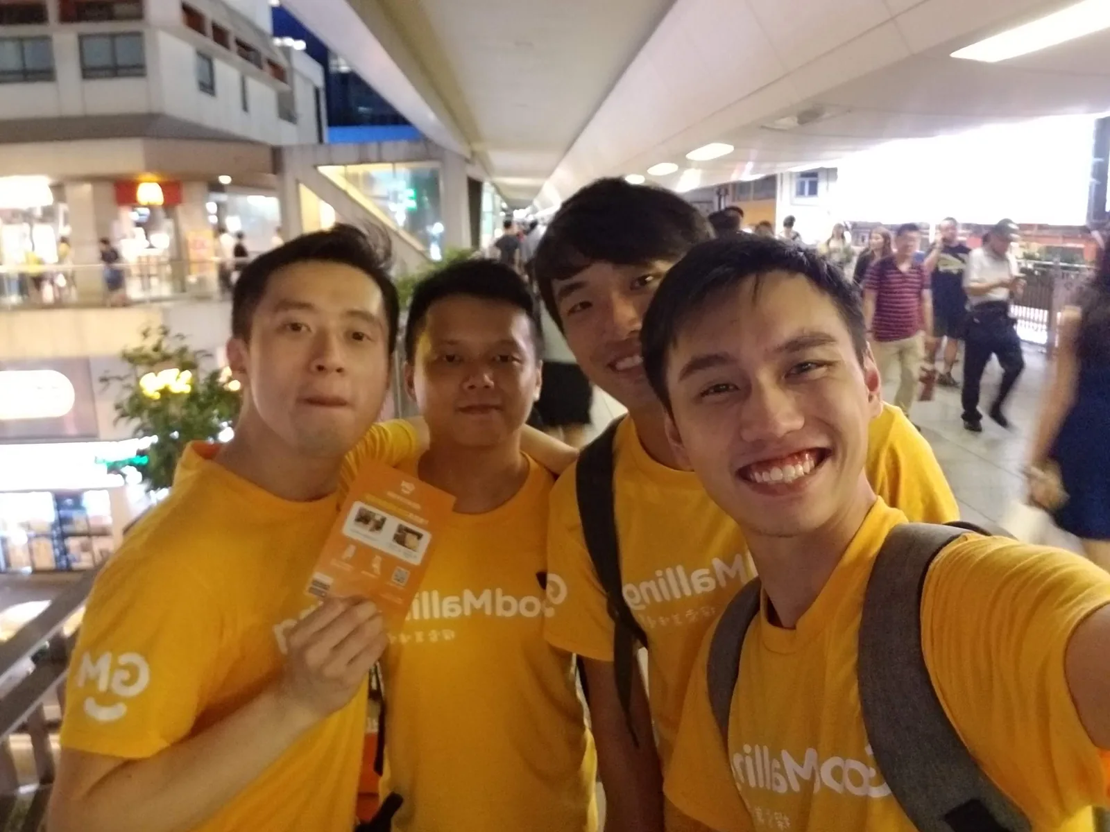 The founding team handing out flyers on a footbridge